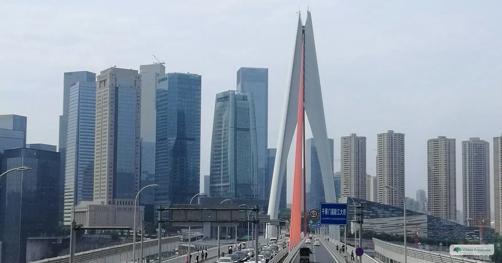Looking along the Qiansimen Bridge from Cangbai Road: the white tower with a red stripe straight ahead and the glass towers of Jiangbeizui behind