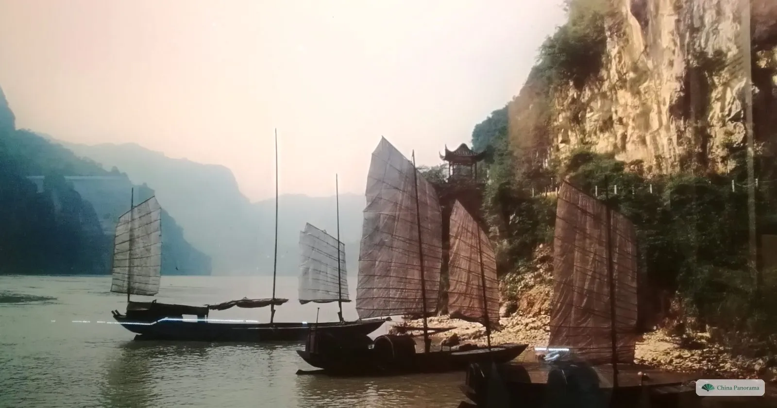 A diorama in the Three Gorges Museum: wooden junks with brown sails moored under misty cliffs, with a small temple on a ledge