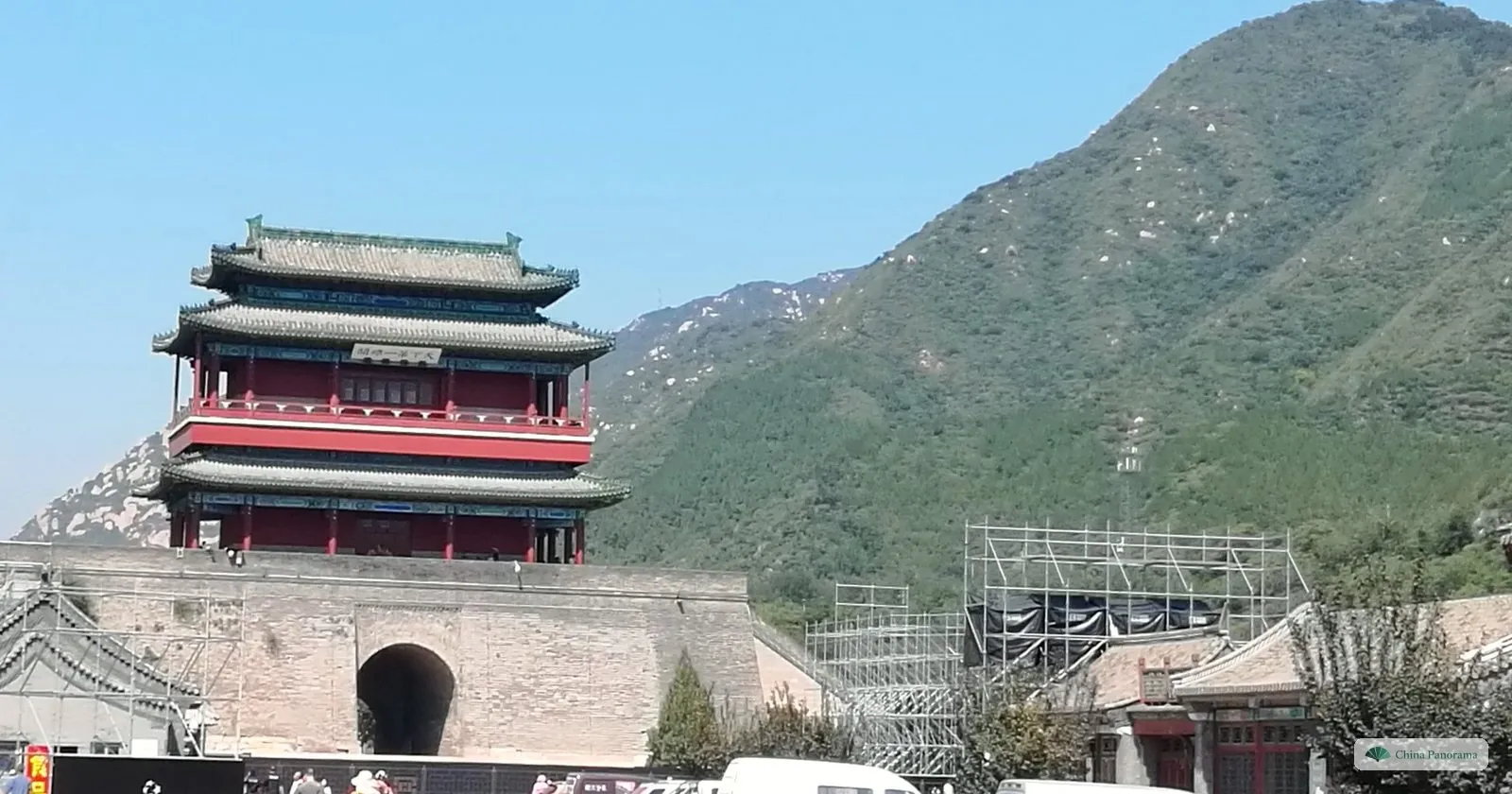The three-storey red and green gate tower of Juyongguan above its arched gateway, with a mountain behind