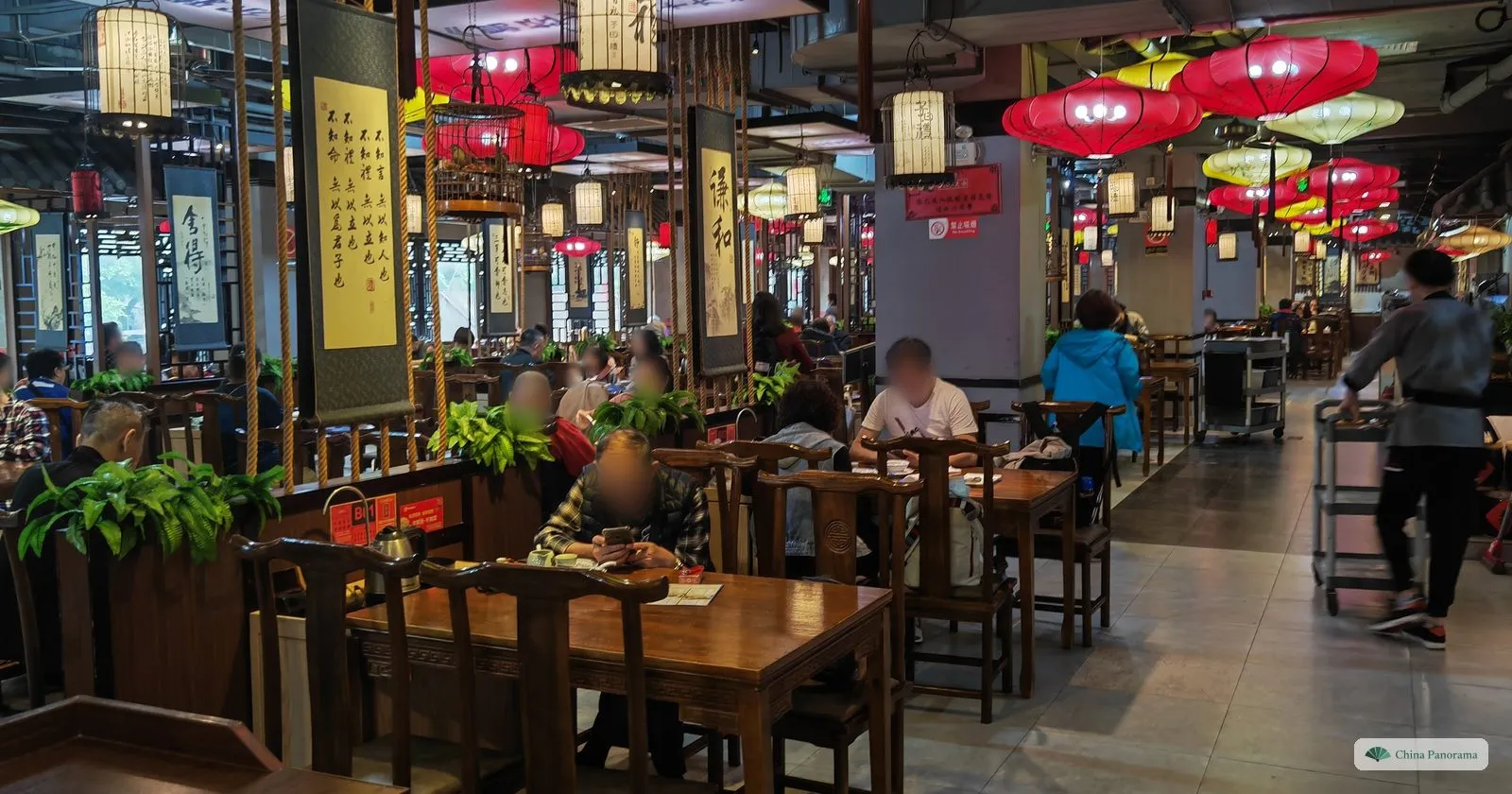 Inside a Cantonese teahouse in the morning: wooden tables and chairs, red lanterns, calligraphy scrolls and a few diners