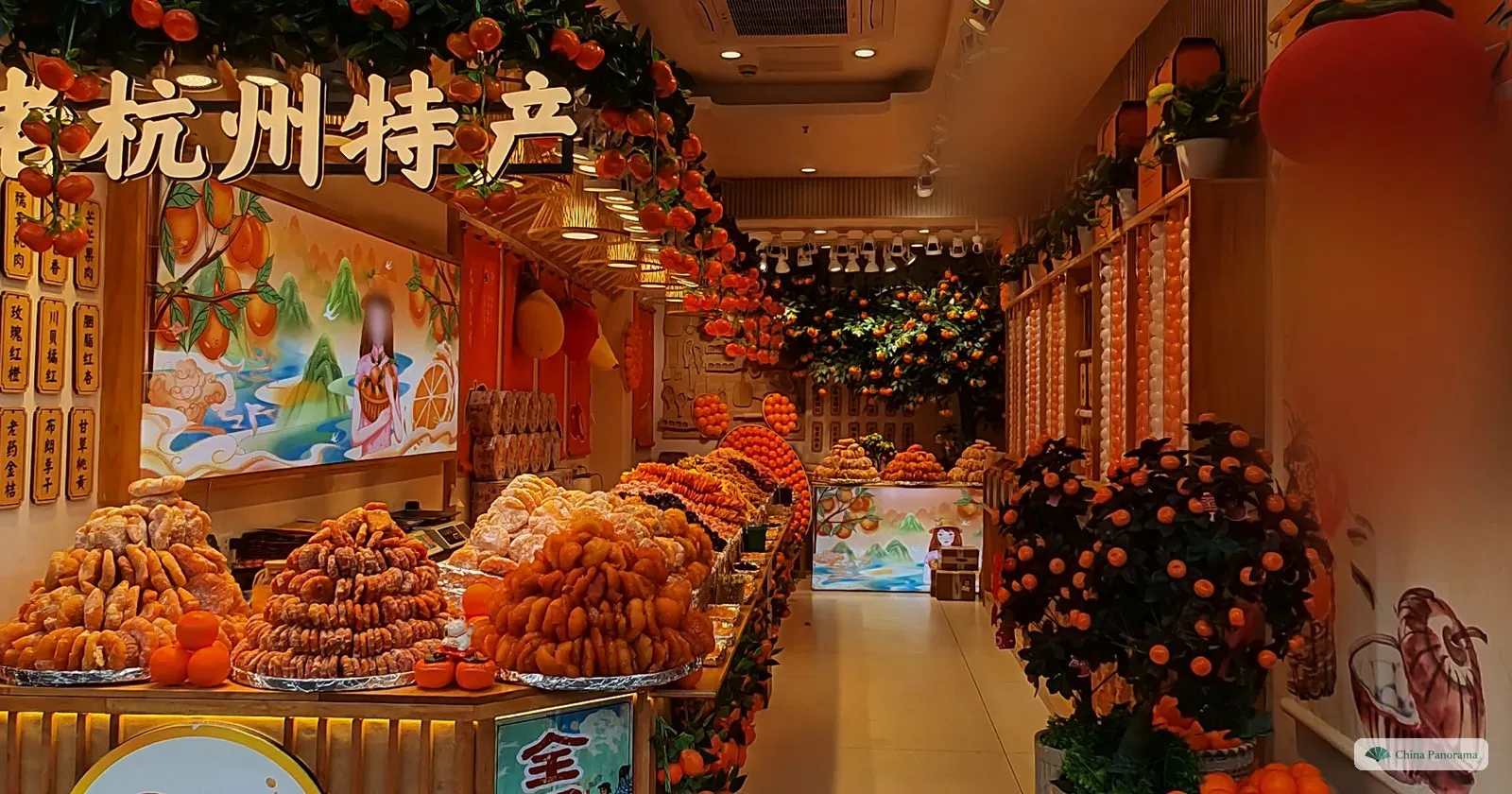 A brightly lit shop full of candied fruit and tangerine displays, a painting of a woman on the wall