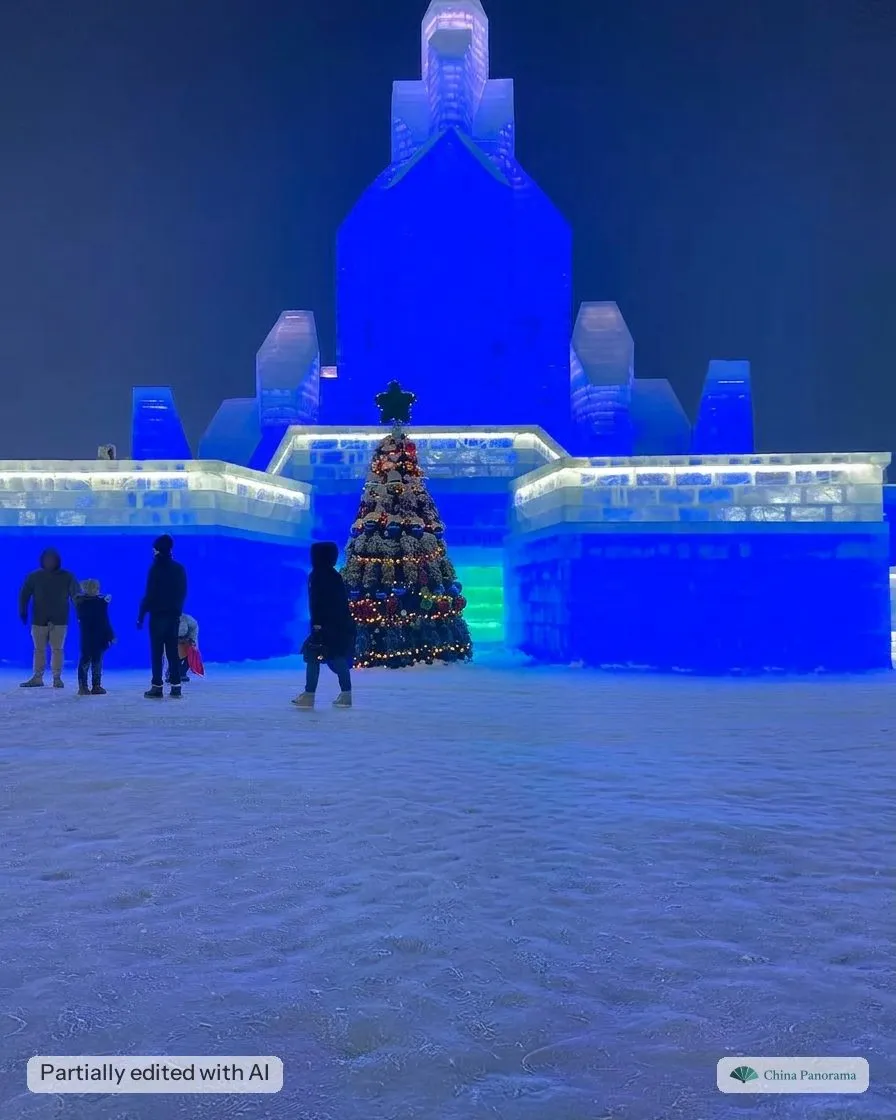 A blue-lit ice castle with a decorated tree at Harbin Ice and Snow World