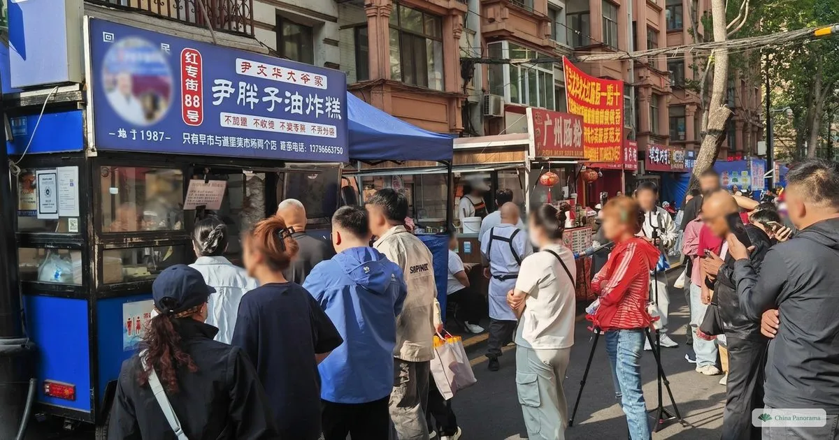 Early-morning crowd around a fried-food stall at the Hongzhuanjie market in Harbin