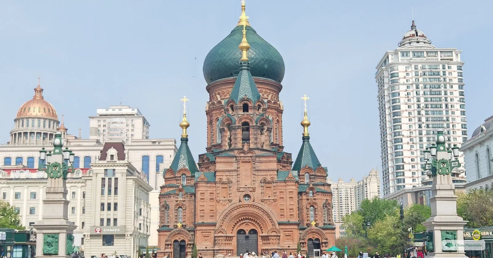 St. Sophia Cathedral in Harbin, red-brick Byzantine-revival church with a green onion dome, seen across the square