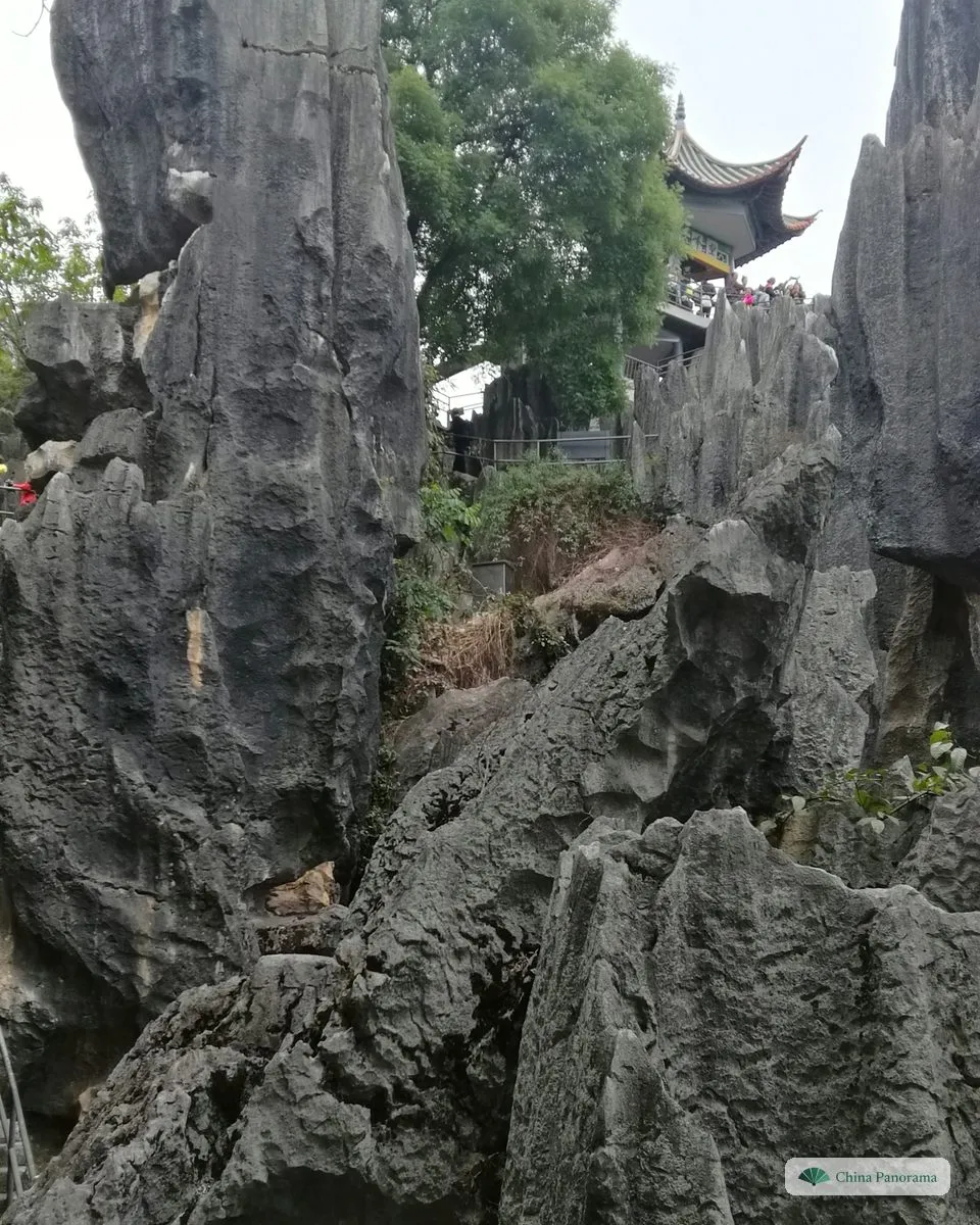 Grey rock spires with a small pavilion roof just visible on top of one of them