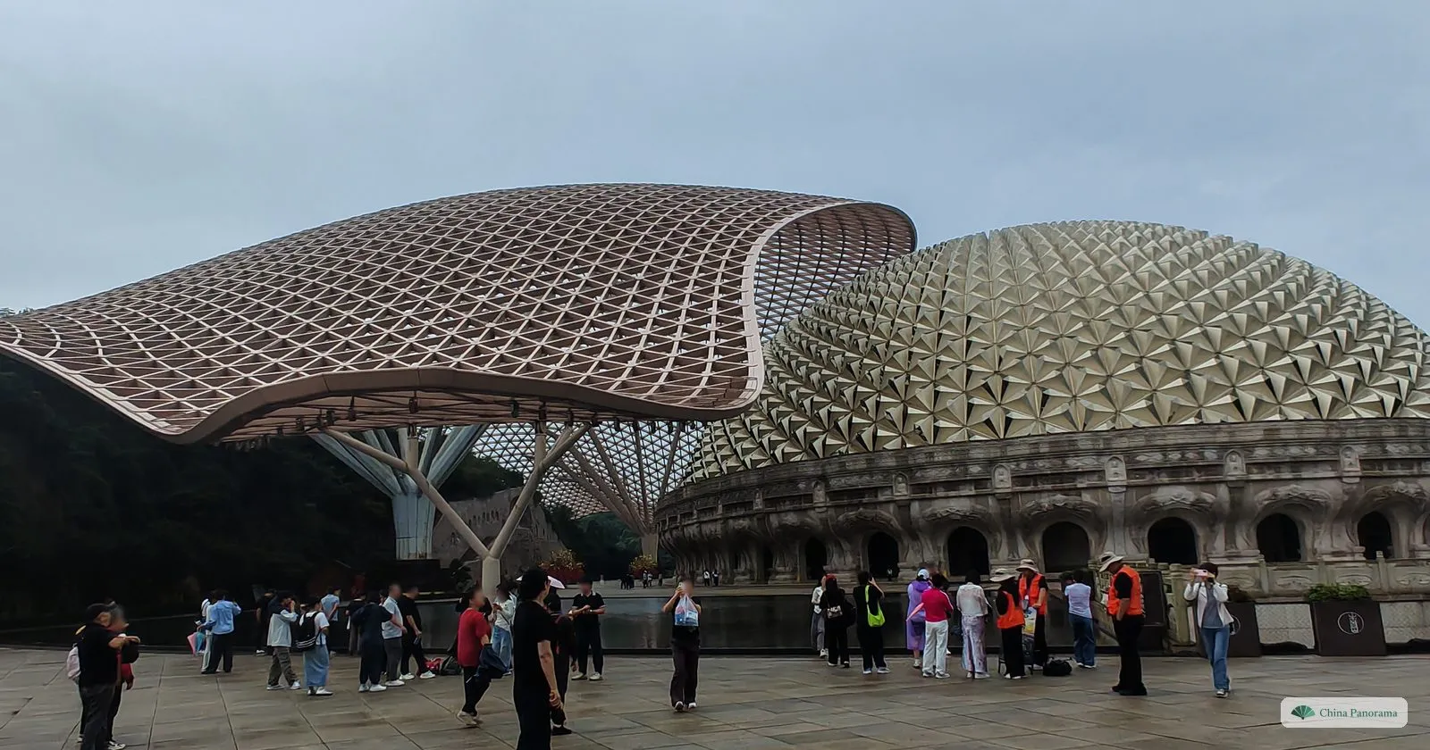 The golden scaled dome of the Usnisha Palace on Niushoushan beside a wave-shaped lattice canopy