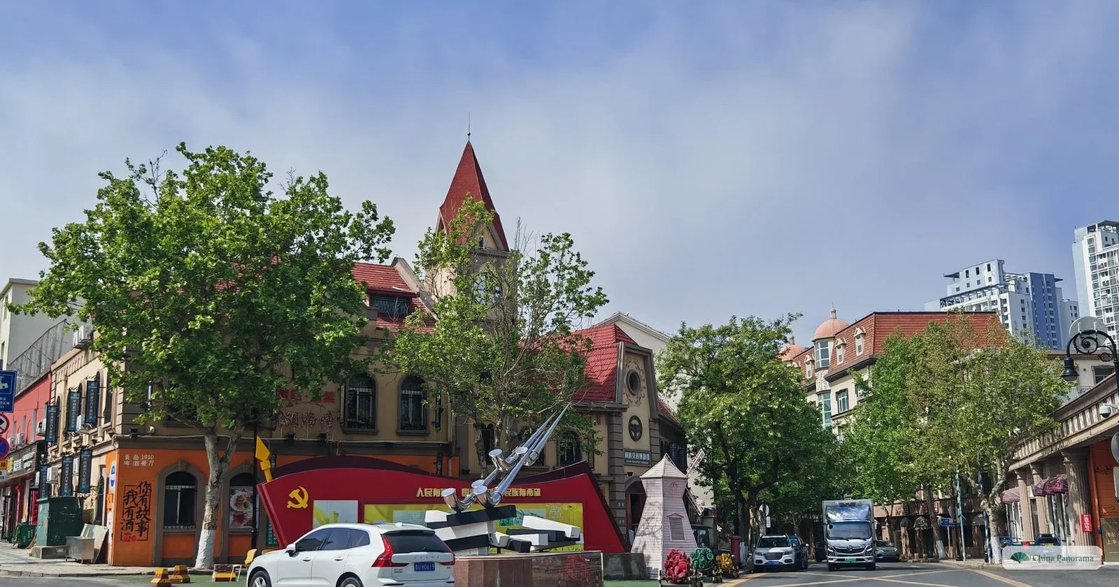 A German-era corner building with a pointed tower on Guantao Road in Qingdao