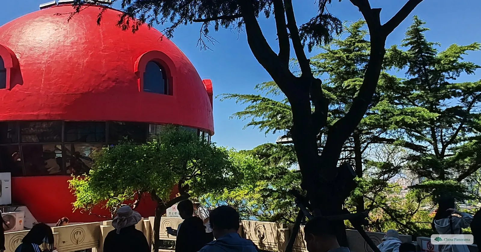 One of the red mushroom-shaped domes on top of Signal Hill in Qingdao, framed by pine branches