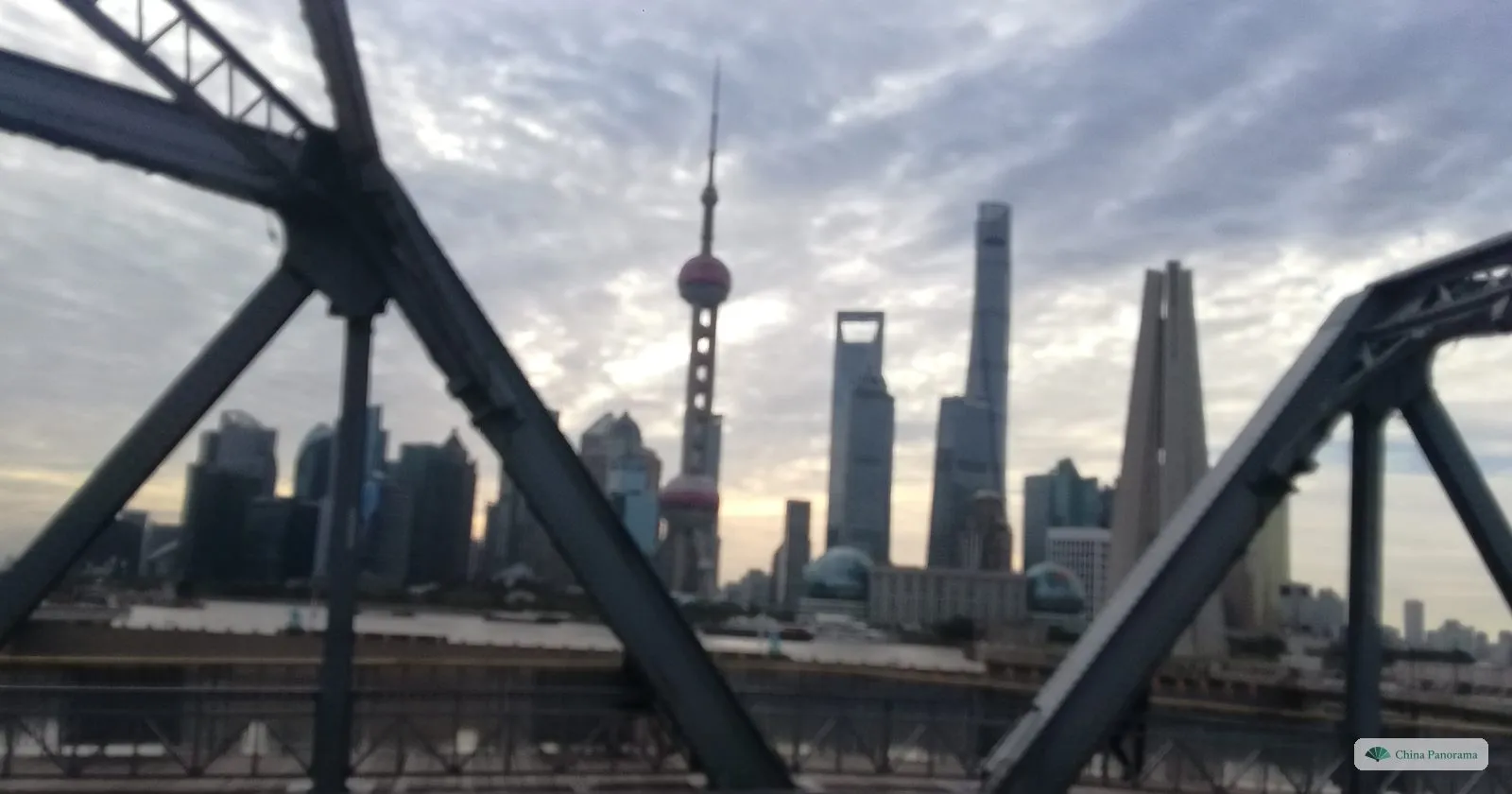 The Lujiazui towers seen through the black steel girders of the Garden Bridge