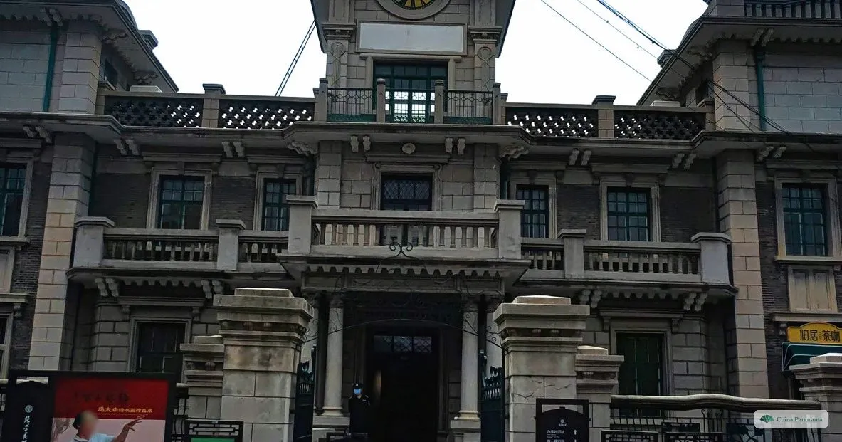 The grey columned stone facade of the former Frontier Bank in Shenyang, seen from the gate