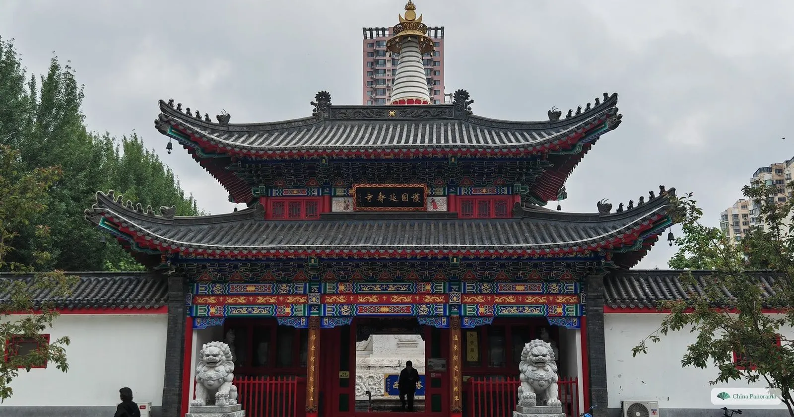 The two-tiered hall of the Yanshou Temple in Xita, with the white West Pagoda rising behind the roof