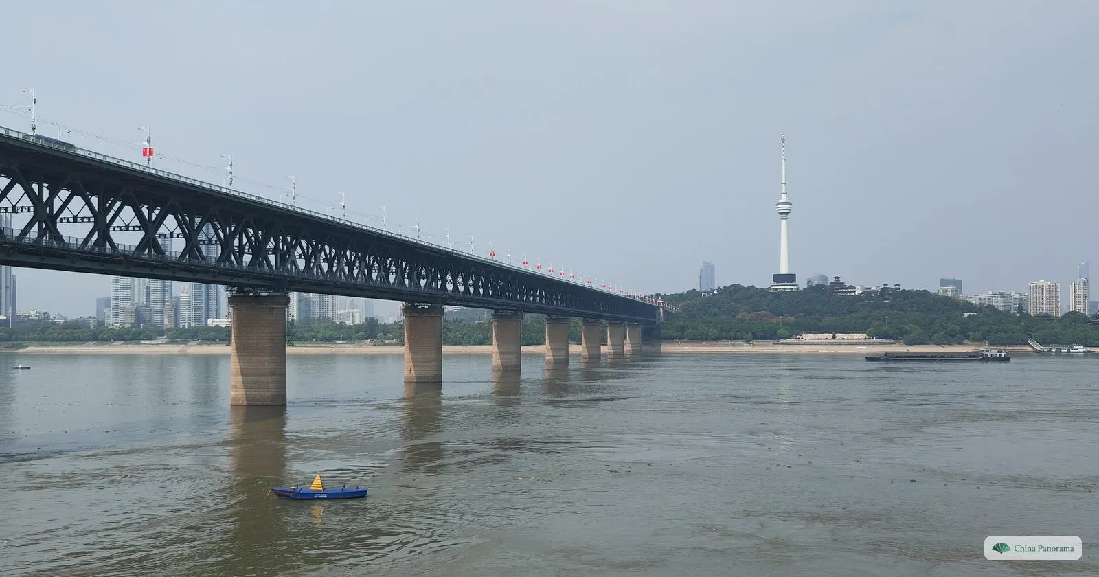 The Wuhan Yangtze River Bridge on its stone piers crossing the wide river to Turtle Hill and its white TV tower