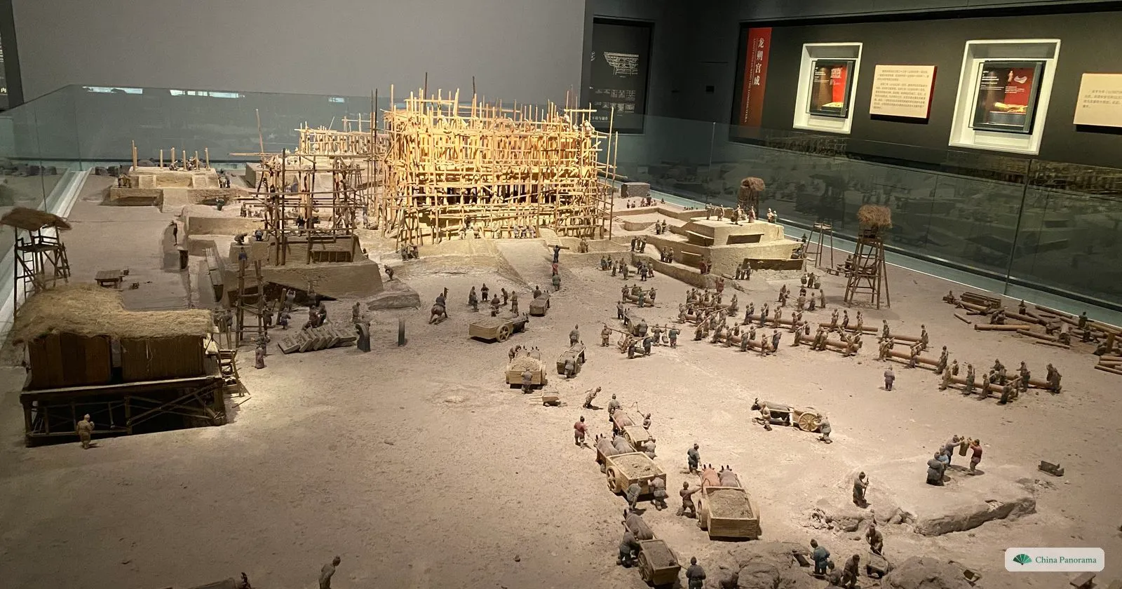 A museum diorama of the building of Daming Palace: small figures hauling stone and timber around a hall still in bamboo scaffolding