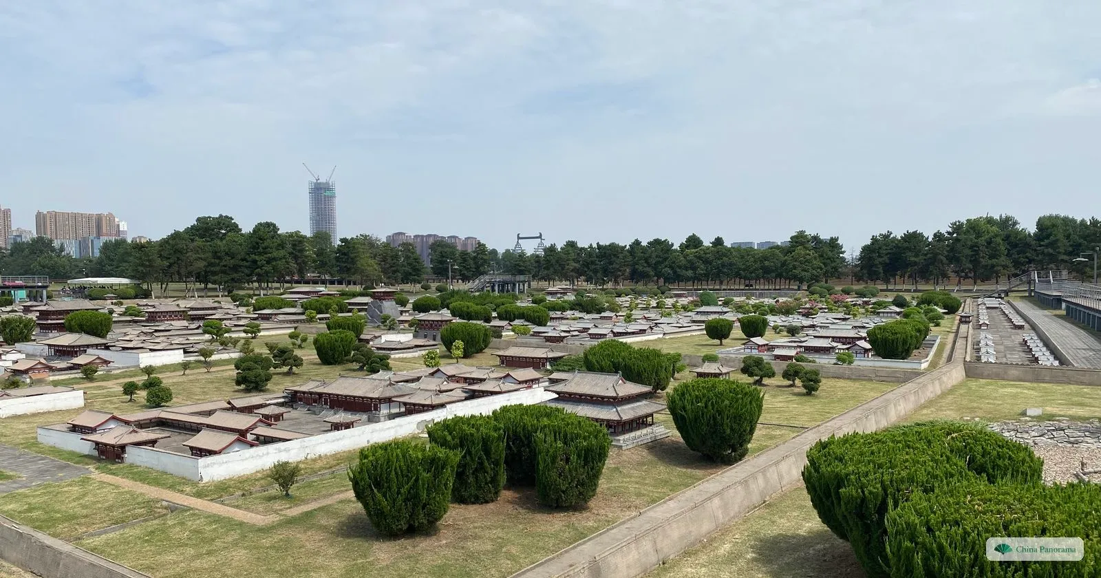 An outdoor scale model of Daming Palace: hundreds of small grey-roofed halls and courtyards laid out on lawns, seen from a viewing platform